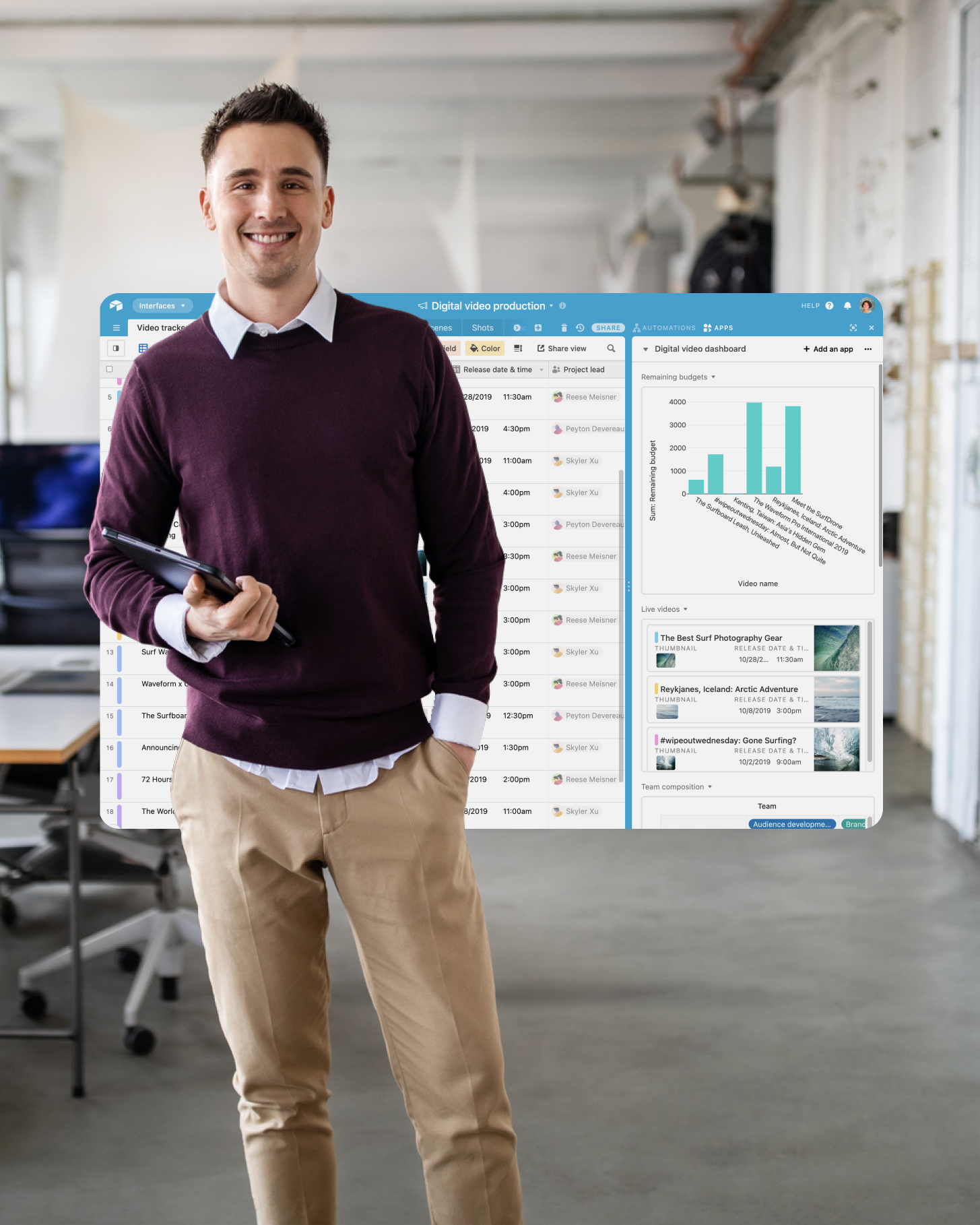 A smiling man stands in front of an Airtable interface tracking the status of sales deals